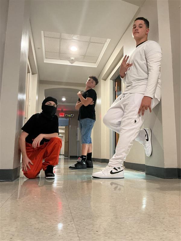 Three students in the hallway.
