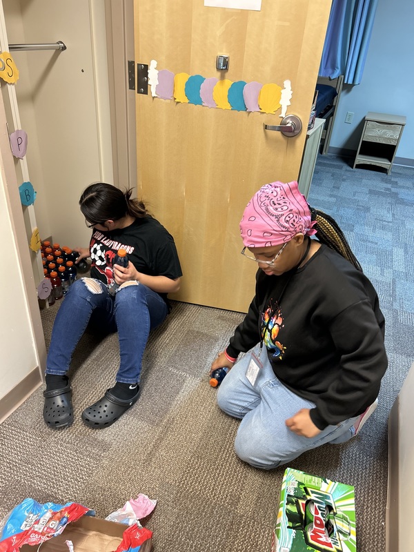 Girls stocking the PBS store with Gatorades