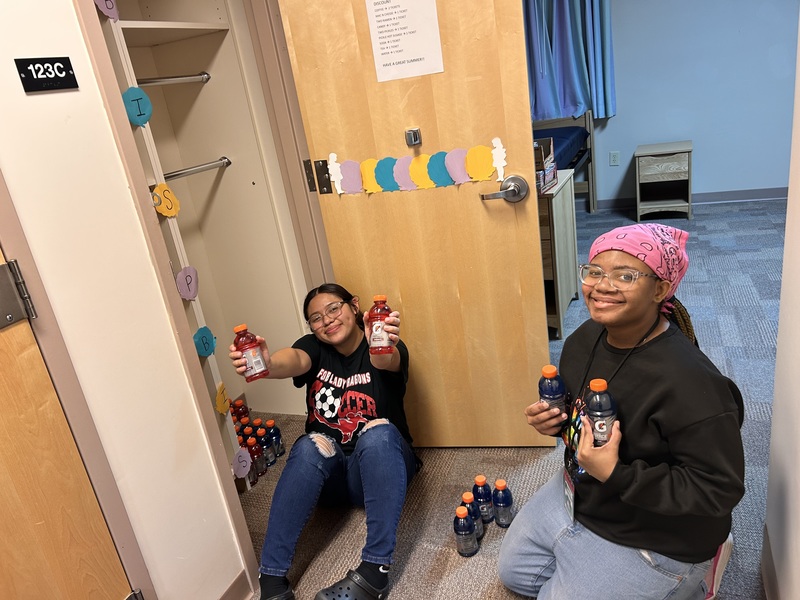 Girls stocking the PBS store with Gatorades