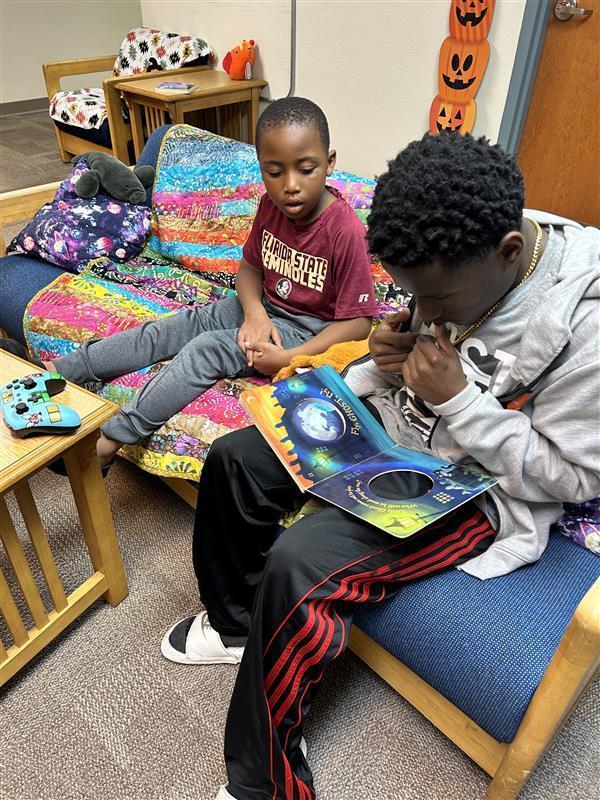 Reading ASL stories to elementary student.