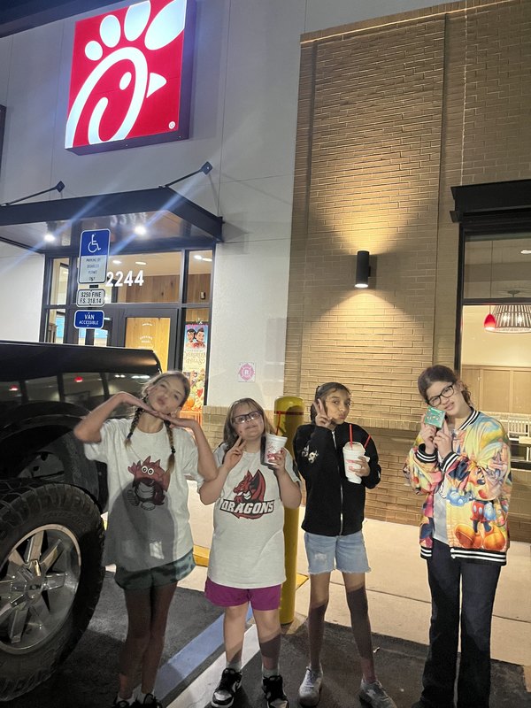 Four girls outside of Chick-Fil-A.