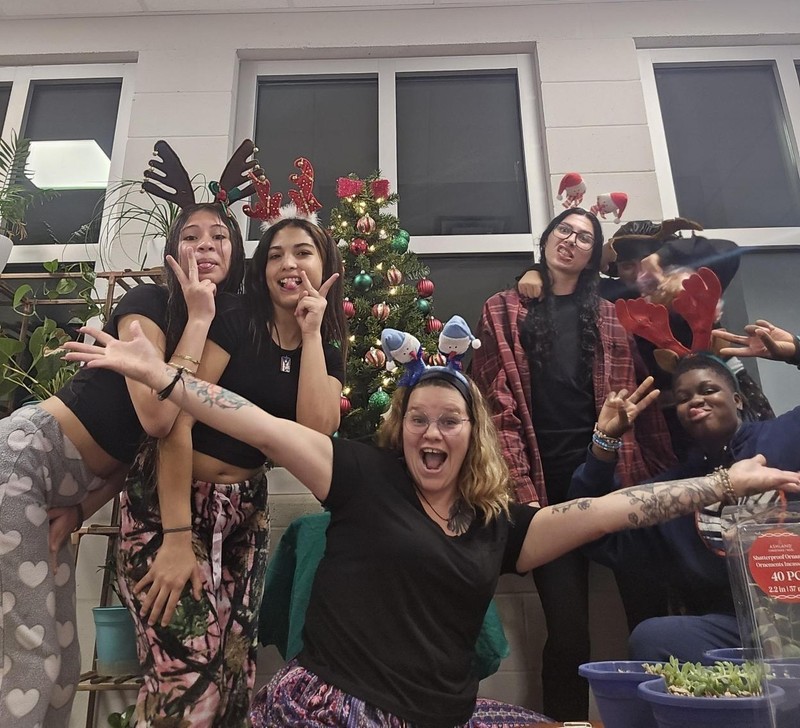 Girls standing in front of their decorated tree.