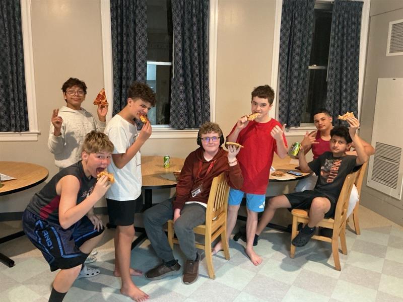 Boys enjoying pizza.