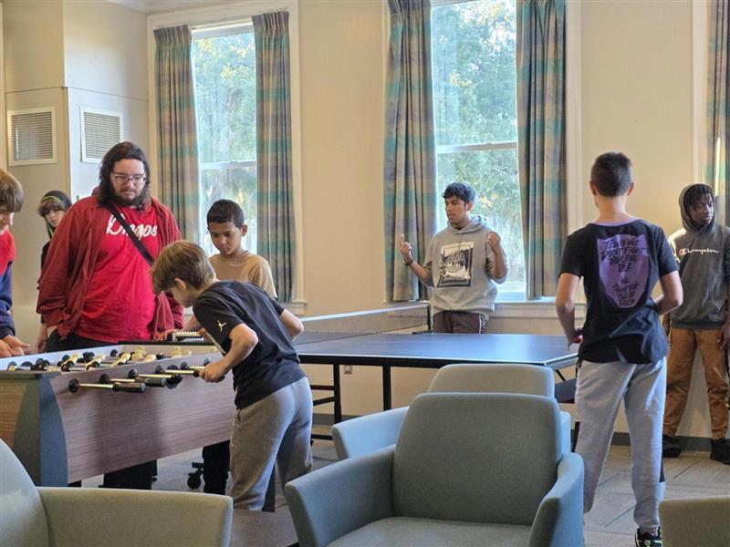 Boys playing games in the rec room.