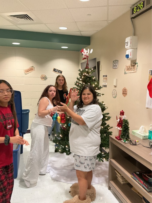 Girls showing off their decorated tree.