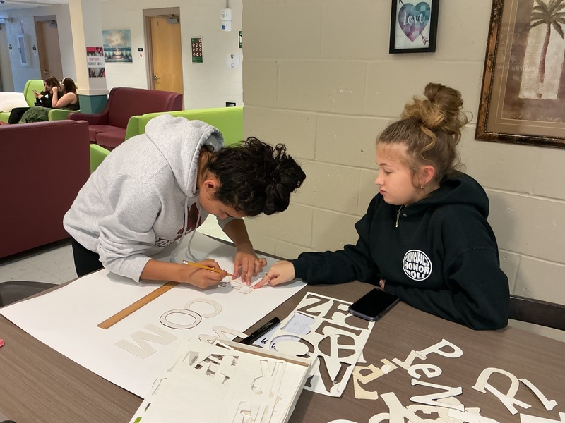 Girls working on "Welcome " signs for Clerc