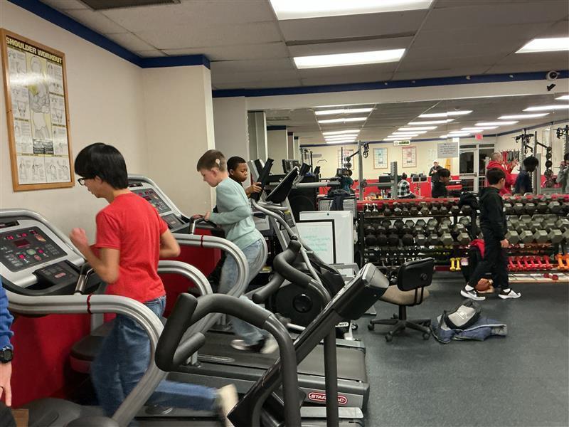 Students running on treadmills in the gym