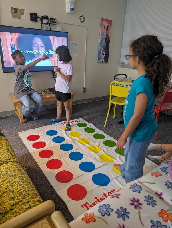Three students playing Twister 