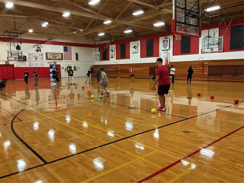 Students playing doge ball in gym
