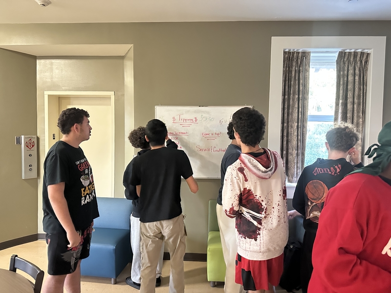 Boy students learning tipping etiquette