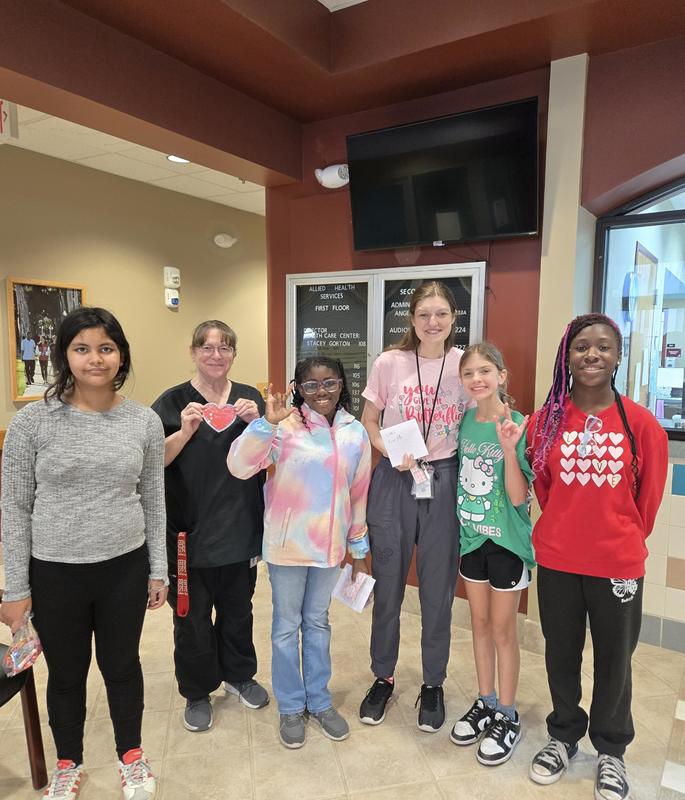 Group of DES Students handing out Valentine's Day cards to staff