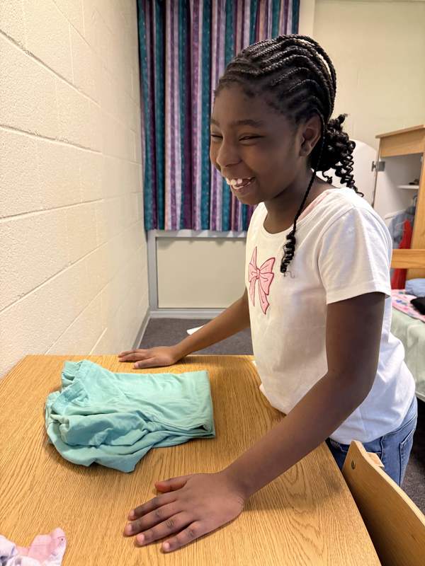 Student folding clothes 