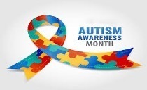 Blue, green, red and yellow puzzle pieces shaped in a ribbon with the words, Autism Awareness Month