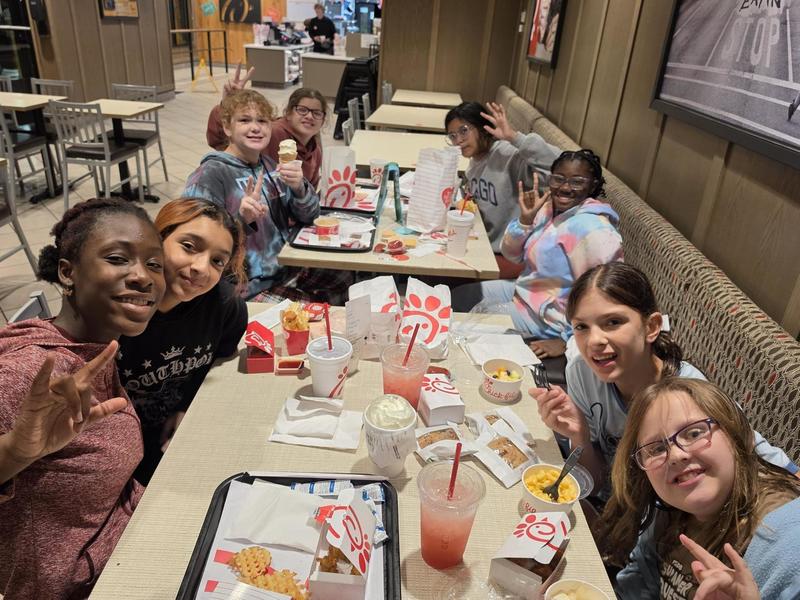 Students sitting down at Chick-fil-A restaurant eating