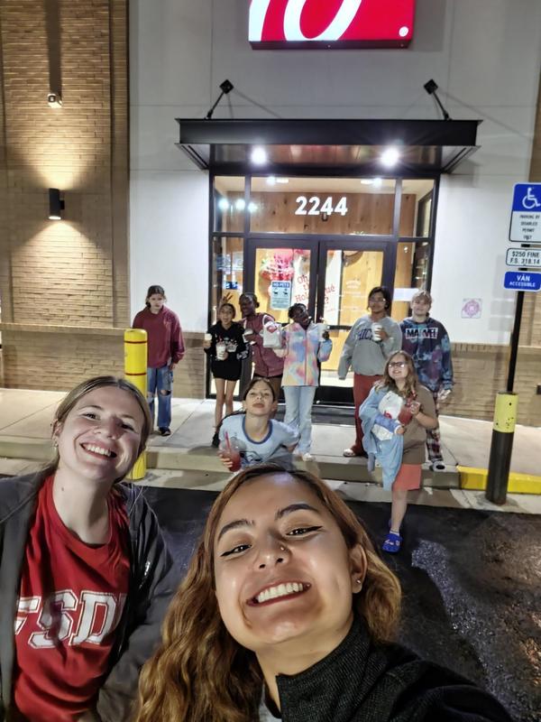Students taking selfie outside of Chick-fil-A