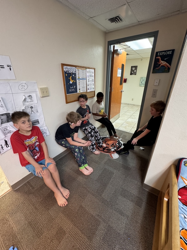Boy students leaning against wall