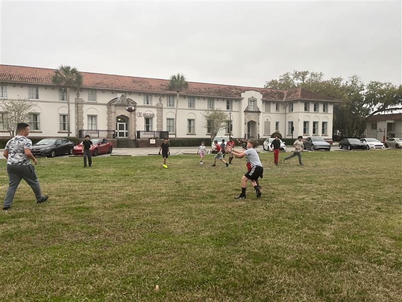 Boys playing outside games in Palm Row