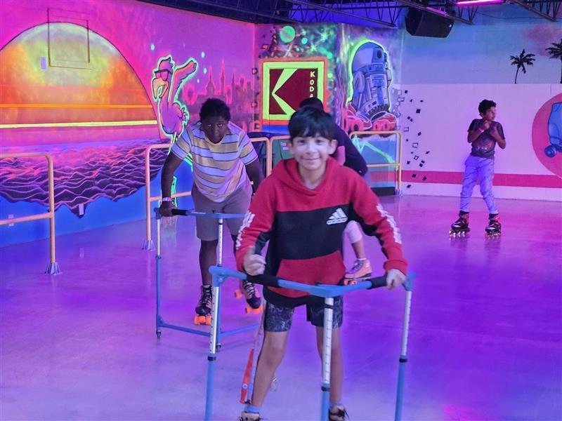 Two students smiling while skating