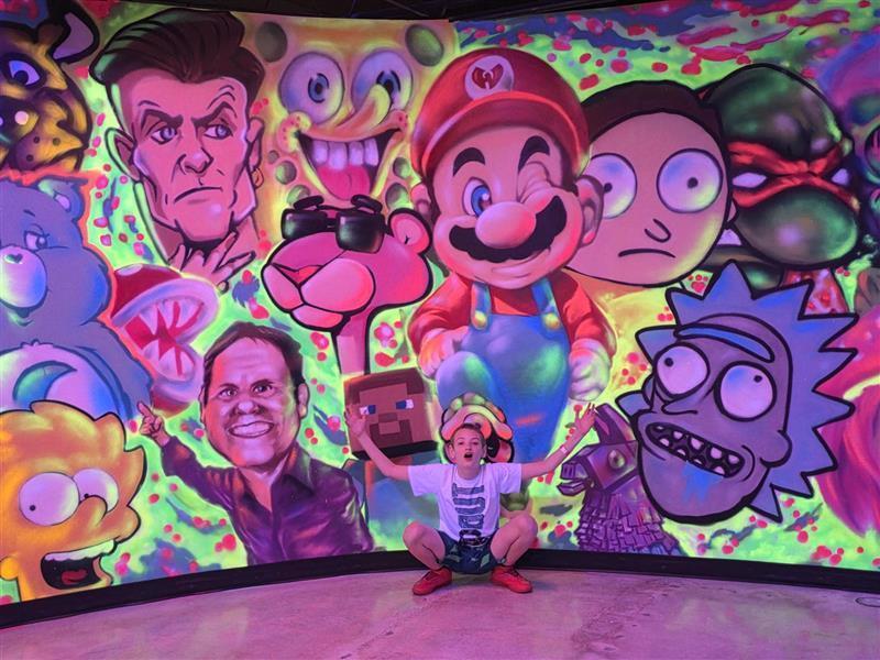 Student posing in front of mural at skating rink