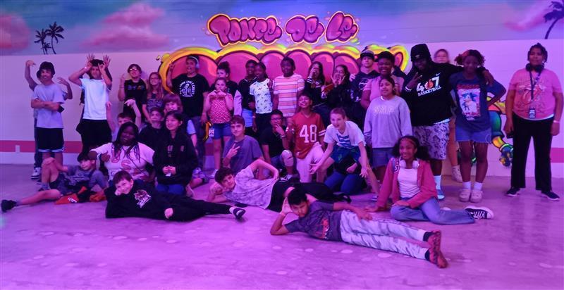 Group of students posing for picture at skating rink