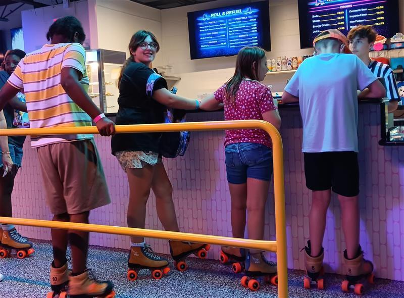Group of kids in concession stand line at skating rink