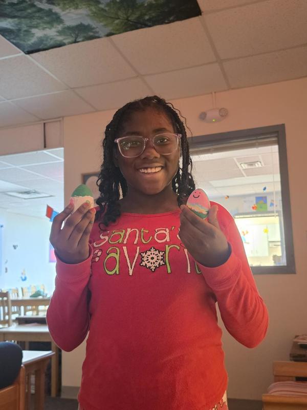 Girl Student holding dyed Easter Eggs