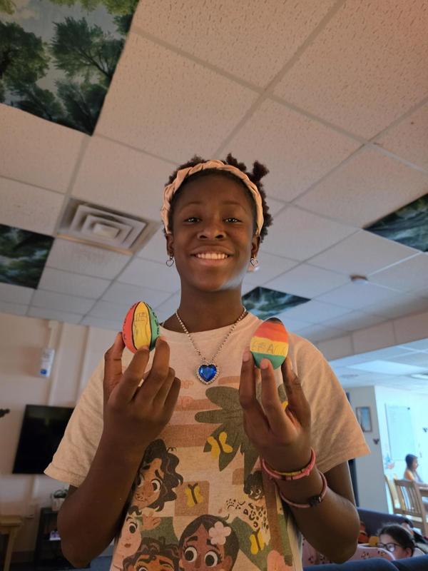 Girl Student holding dyed Easter Eggs