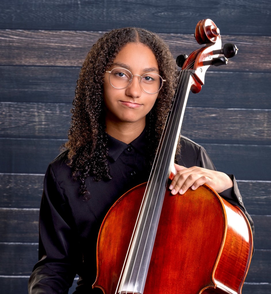 student holding a cello