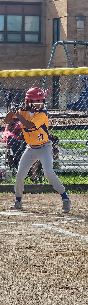 girl playing softball at bat 