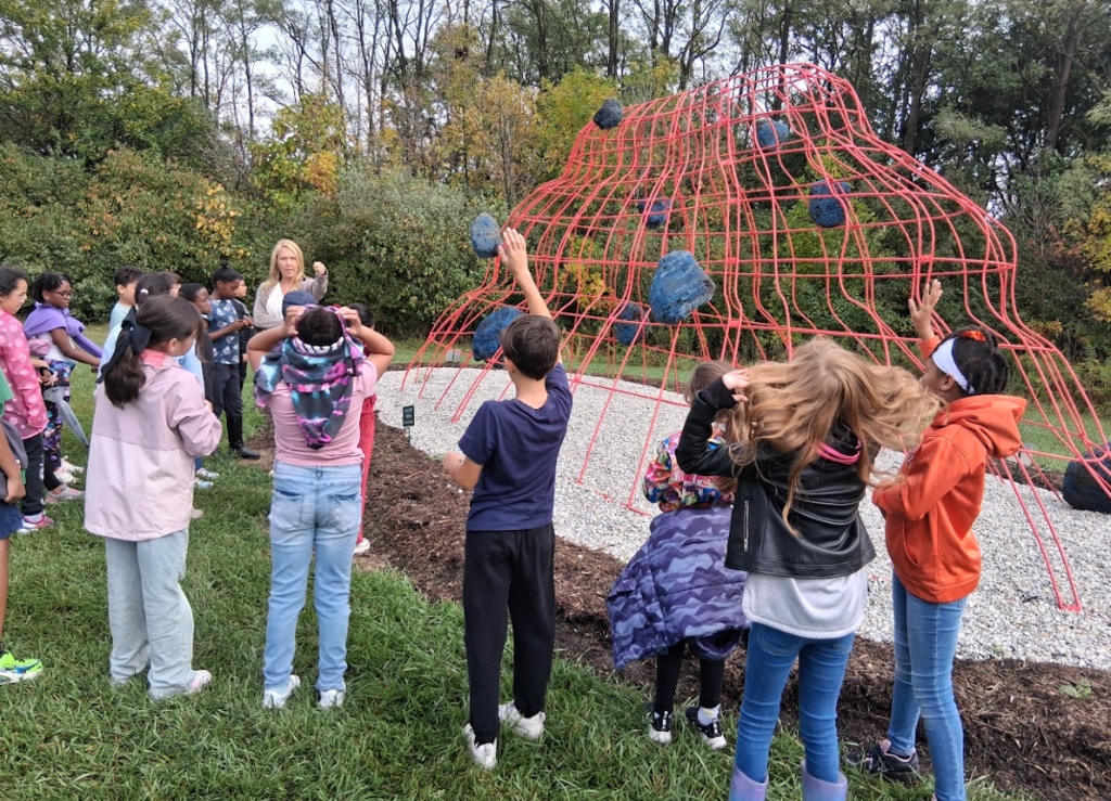 students looking at a sculpture