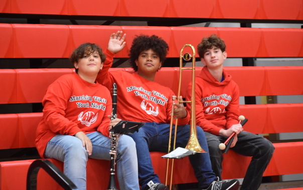 three boys holding their instruments