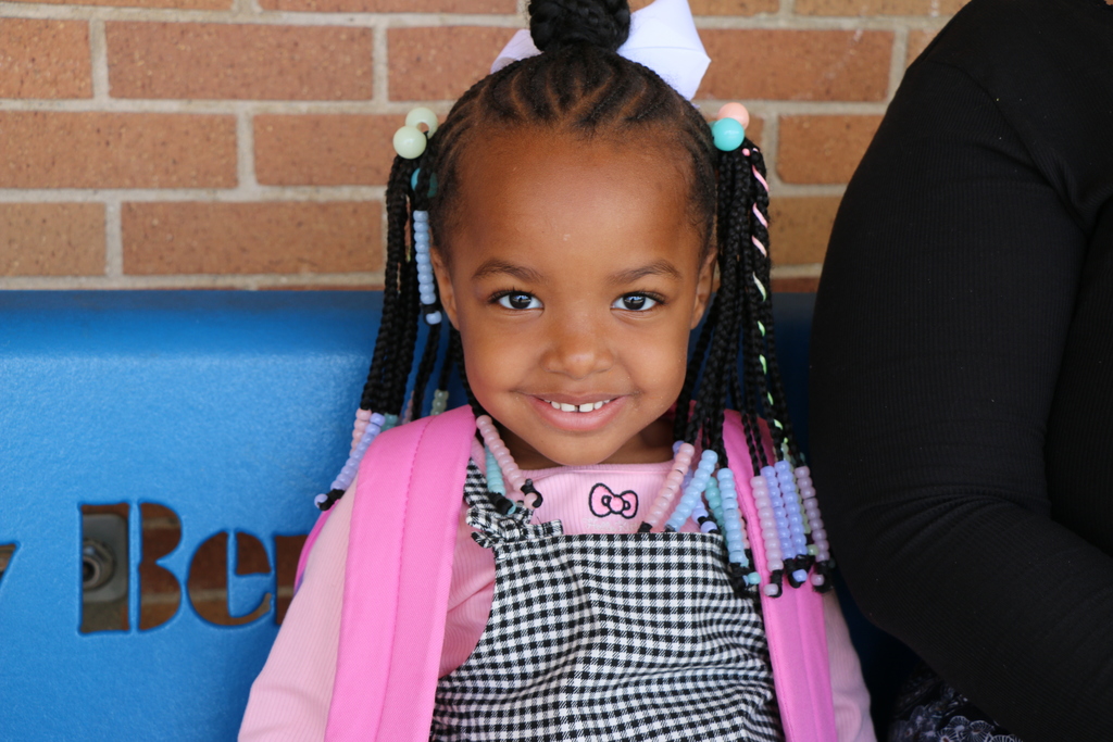 child sitting on a bench. 
