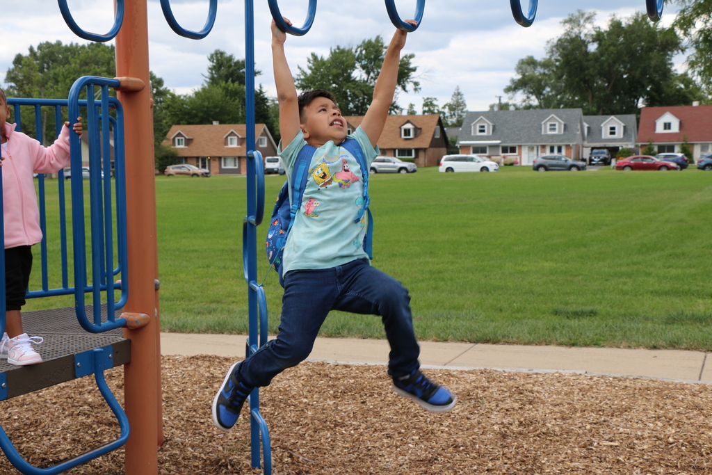 child playing on playground monkey bars. 