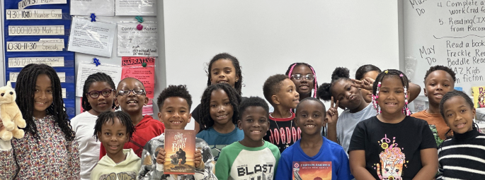 School kids reading a book. 
