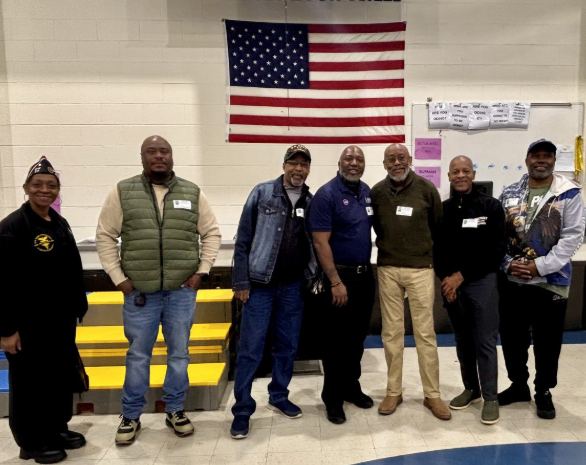 Veterans standing in front of a flag