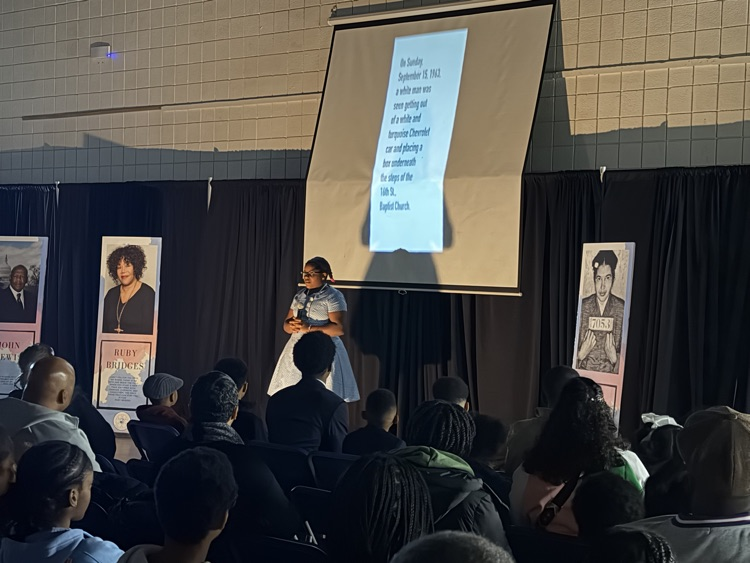 A performer in a dark room with a spotlight