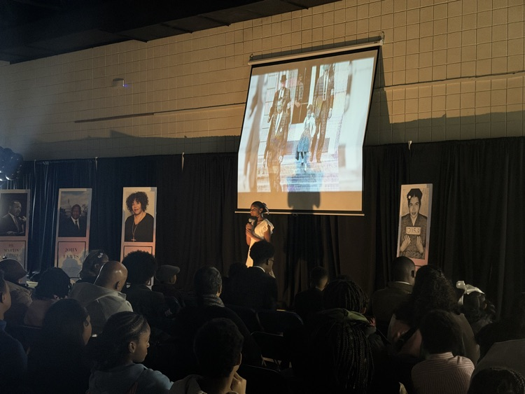 performer in a dark room with a spotlight