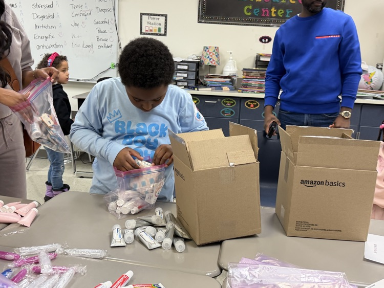 child filling a box. 