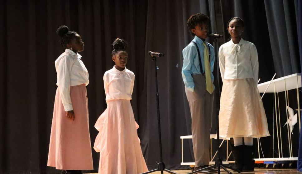 kids singing on stage