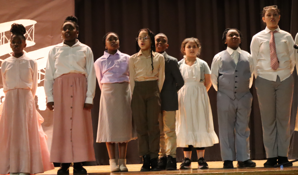 kids singing on stage