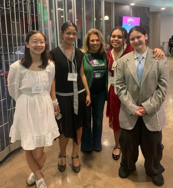 kids posing with their teacher 