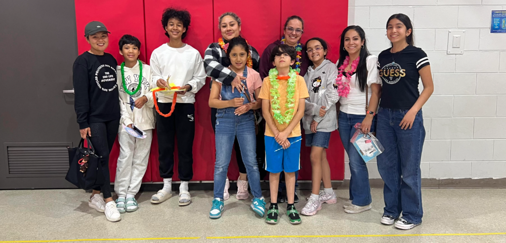 A family with students at a school event 