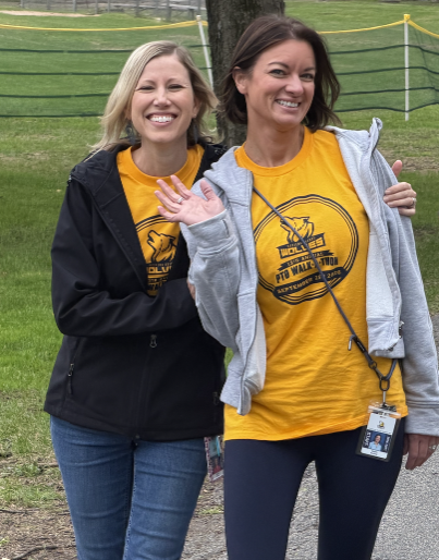 two reading teachers waving