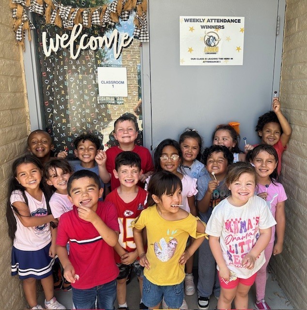 Mrs. Hurst's kindergarten class standing in front of their door