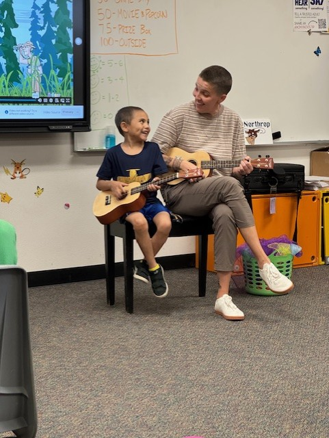 Mrs. Northrop and a student playing ukuleles together