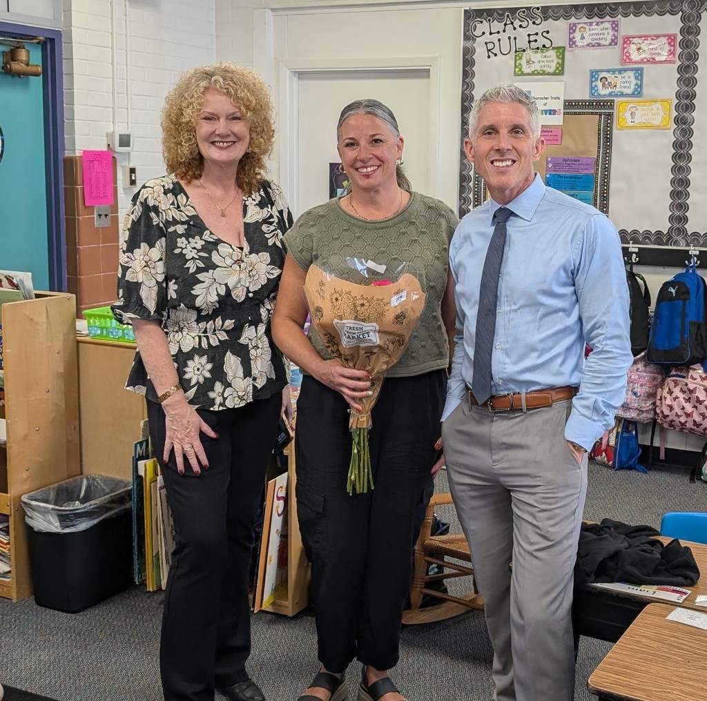Dr. Tamara McAllister, Janelle Thomas, and Dr. Kevin Stoltzfus smile together in a classroom.