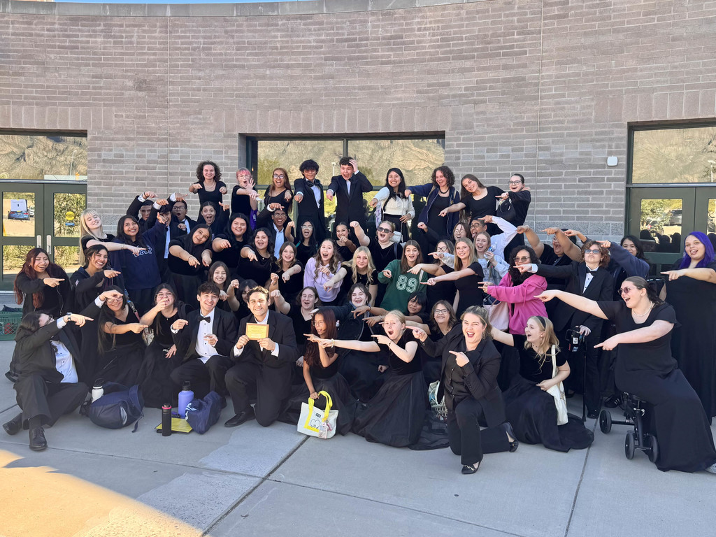 Flowing Wells High School Bella Voce and Choralires students point playfully toward their award while celebrating their Superior with Distinction ratings at the ACE Fall Choral Festival.