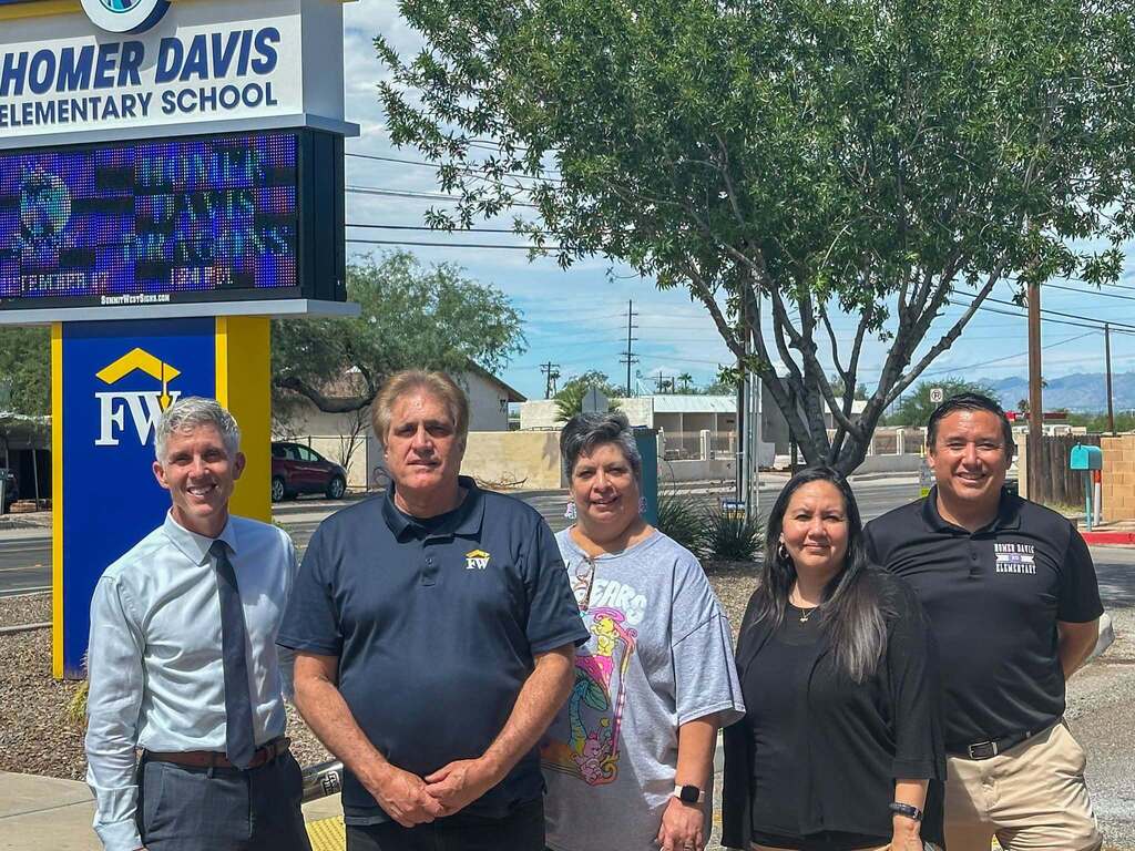 Flowing Wells Governing Board and District Administration stand and pose in front of Homer Davis Elementary