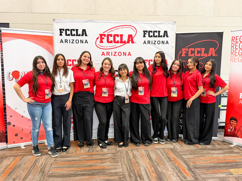 Ten Education Professions  students stand together in front of an FCCLA backdrop. 