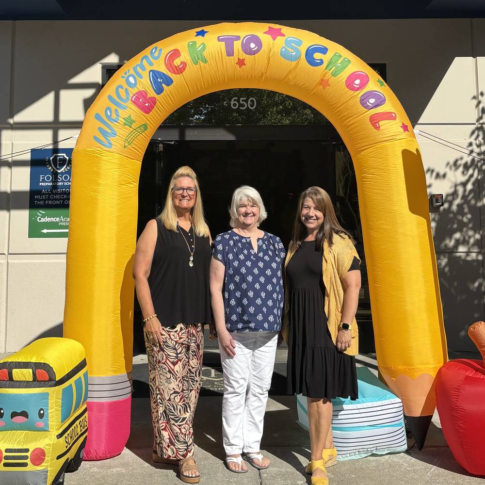 Office staff in front of school